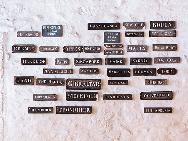 Brown metal tag on white stucco wall